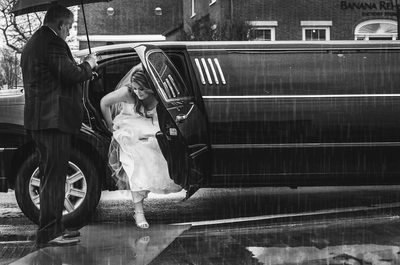 Bride arriving by limo in the rain